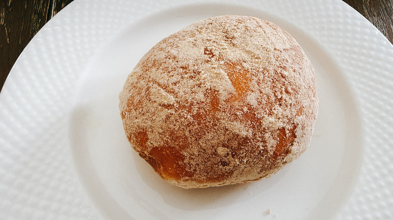 Krispy Kreme Cinnamon Apple Filled Doughnut on white plate
