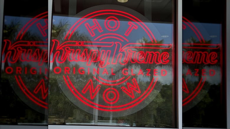 Krispy Kreme original glazed Hot Now neon sign illuminated in store window