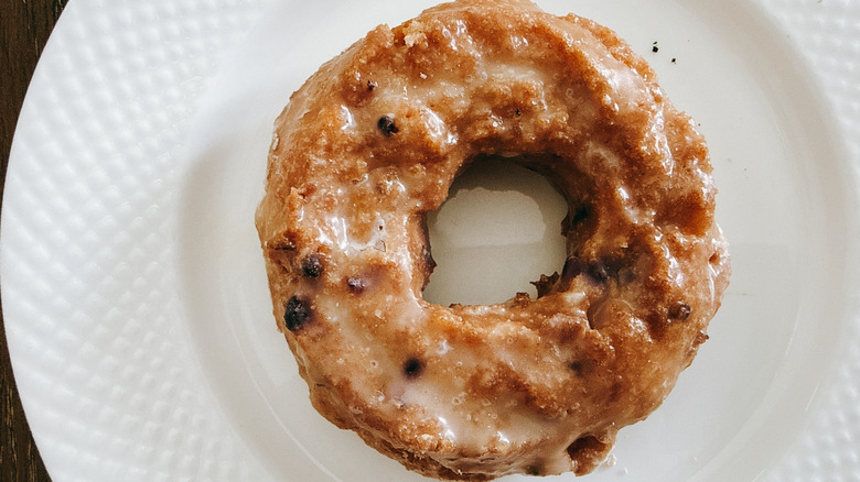 Krispy Kreme Original Glazed Blueberry Cake Doughnut on white plate