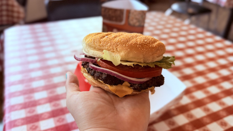 Hand holding cheeseburger at Portillo's