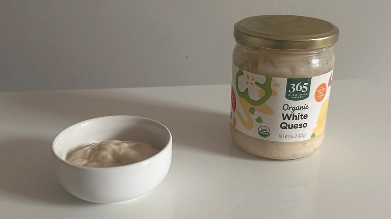 A jar of 365 White queso spooned into a little white bowl