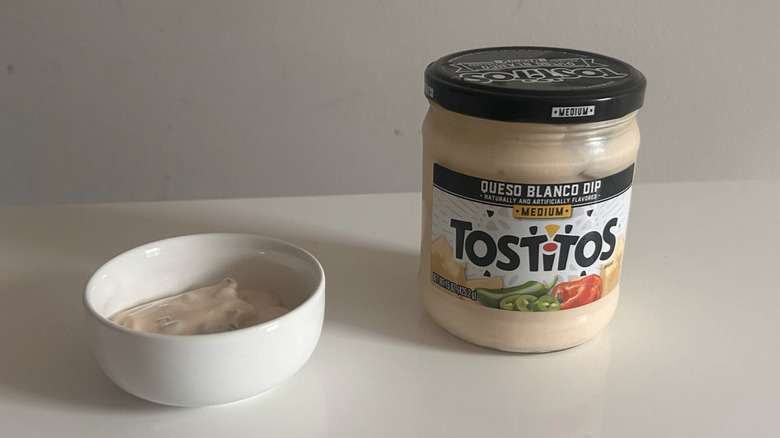 A jar next to a bowl with Tostitos queso blanco