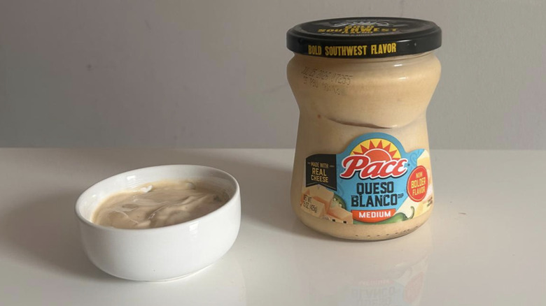 A jar of Pace queso blanco spooned into a small white bowl