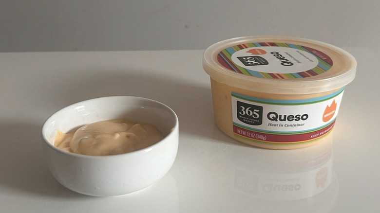 A tub of 365 medium heat queso poured into a bowl