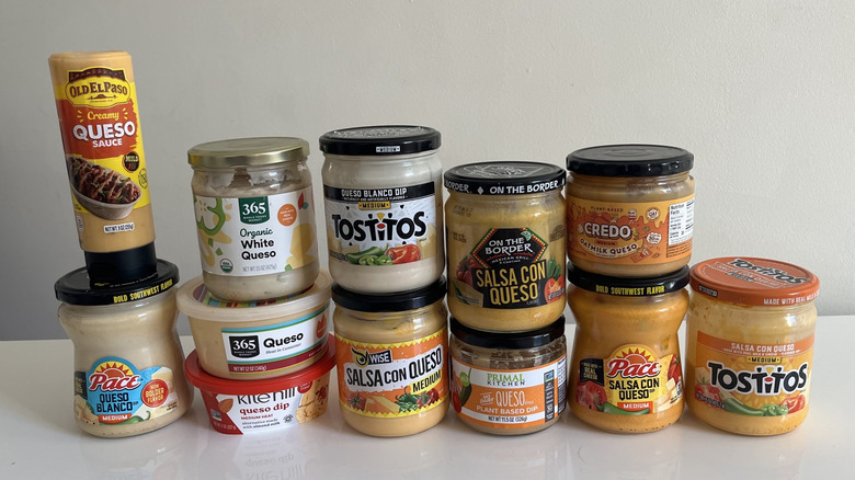 12 jars of queso arranged in a line