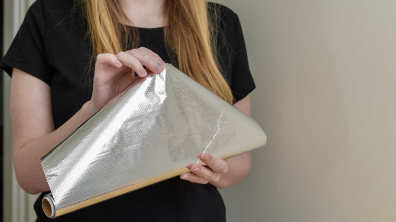 Woman holding aluminum foil