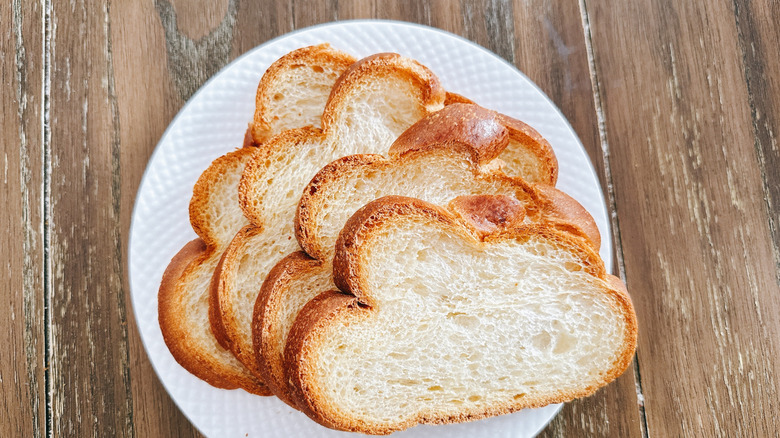 Publix challah slices on white plate on wooden table