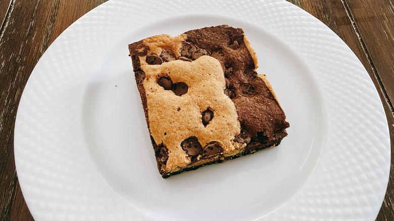 Publix brookie on white plate on wooden table