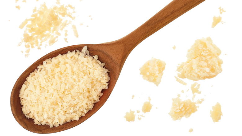 Grated parmesan cheese in a wooden spoon