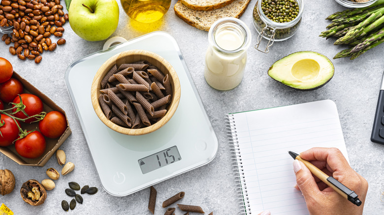 Person using kitchen scale to calculate the right portion