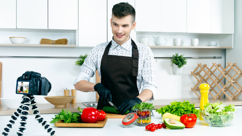 Man shooting a video in a home kitchen