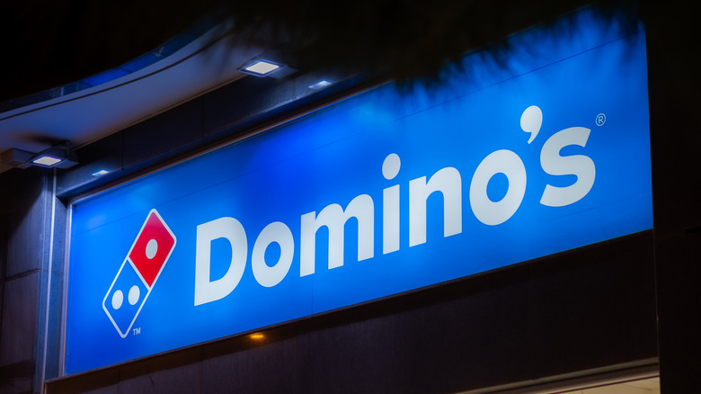 The exterior of a Domino's, night