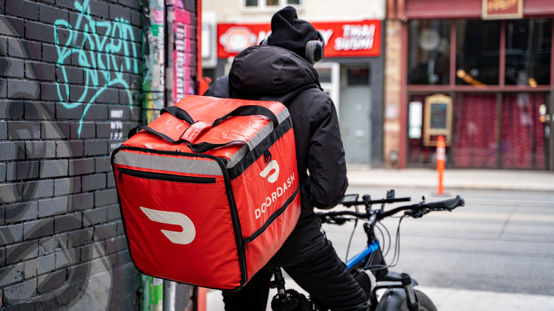 DoorDash delivery driver on a bicycle