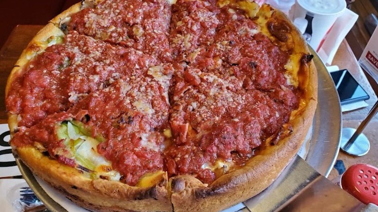 A closeup of Bartoli's Chicago deep dish pizza being served