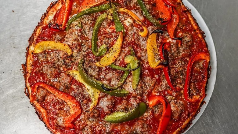 A close-up of Burt's Place pan pizza with bell peppers
