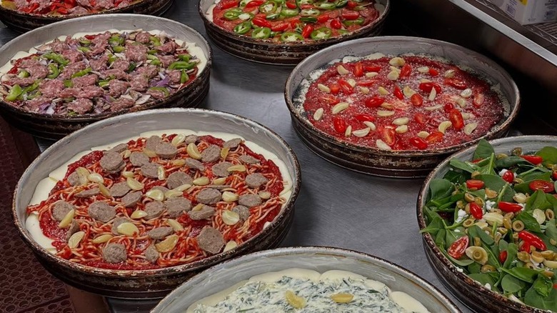 A lineup of George's Deep Dish pizzas with unique toppings