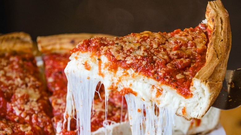 Slice of Giordano's Chicago deep dish pizza being lifted