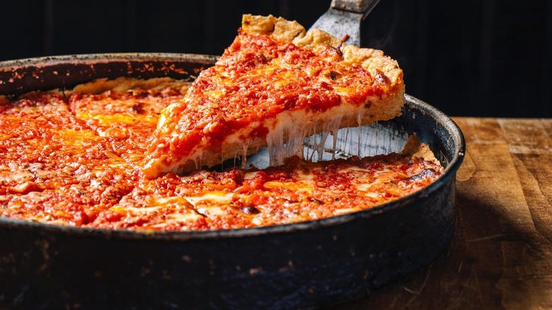 A slice being lifted from Lou Malnati's deep dish pizza