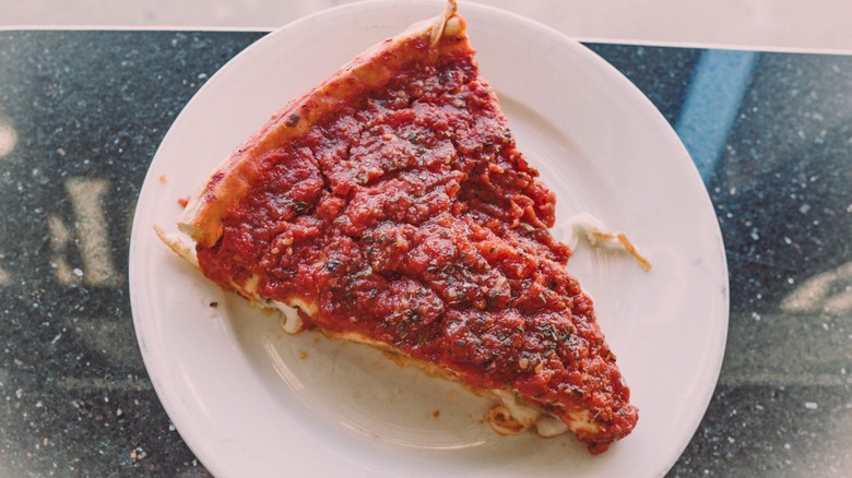 A slice of deep dish from The Art of Pizza in Chicago