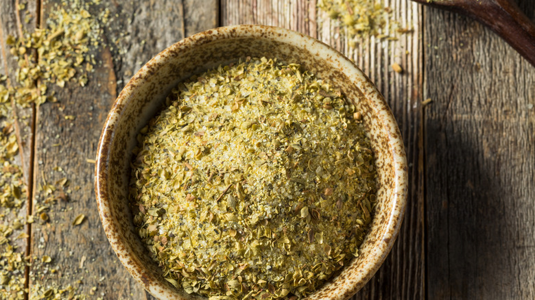 Dry adobo seasoning in a bowl on a wooden surface