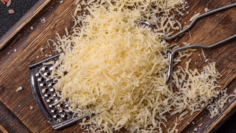 Grated Parmesan cheese on a wooden board