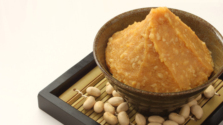 Miso in a dish and some soybeans