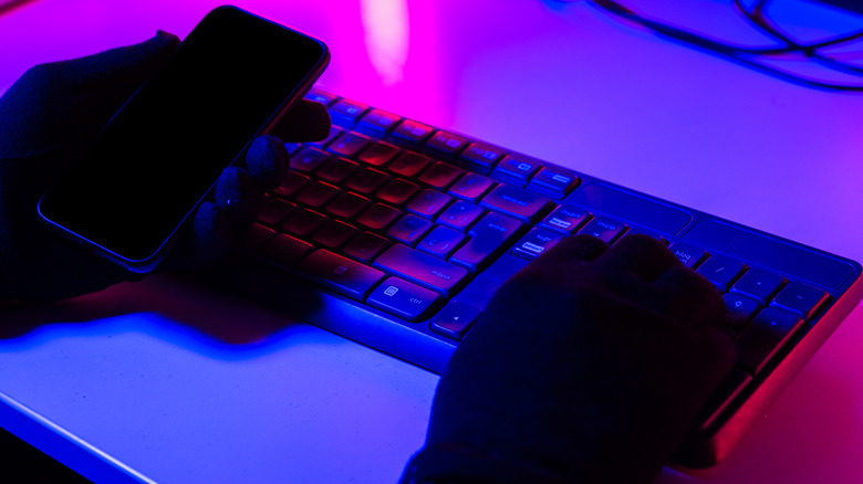 Hacker in neon purple light