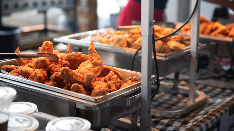 food under a heat lamp at a buffet