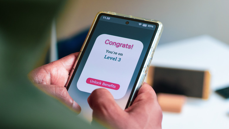 Cellphone with rewards program on screen