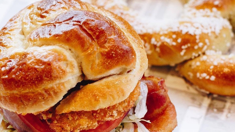 Sheetz pretzel bun sandwich with a large soft pretzel in the background