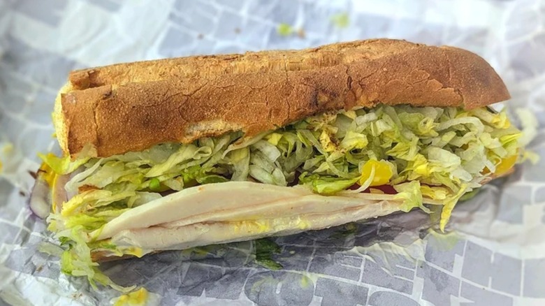 A Sheetz turkey sub with lettuce, cheese and more toppings on a wrapper