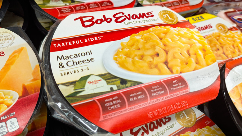 A photo of packages of Bob Evans macaroni & cheese side dishes in a grocery store display.