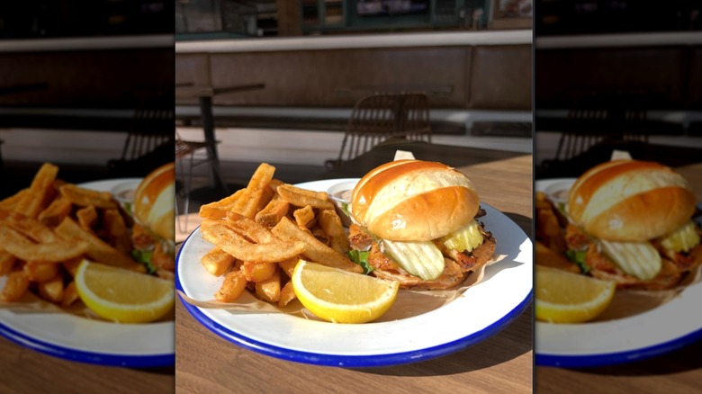 Brown Bag Seafood Co. fish sandwich on plate.
