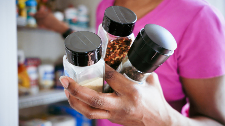 Woman holding jars of spices