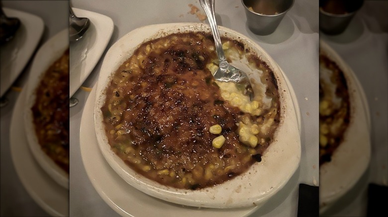 Perry's Steakhouse & Grille's Corn brûlée with silver spoon in white serving dish