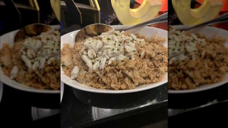 Eddie V's Crab Fried Rice in white dish with silver serving spoon