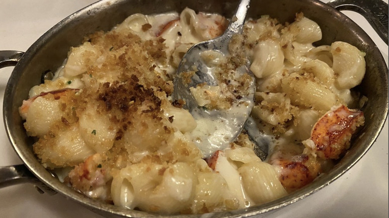 Del Frisco's Double Eagle Steakhouse lobster mac and cheese in silver serving dish with spoon