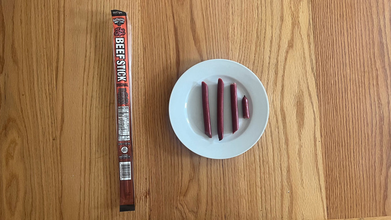 An Old Trapper meat stick cut up on a plate