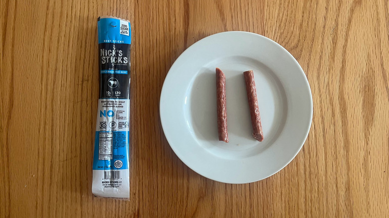 A package of Nick's Sticks with one on a plate