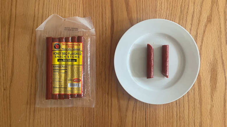 A package of Wisconsin's Best meat sticks next to a plate