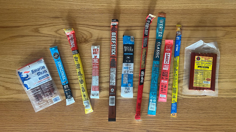 An array of meat sticks on a wooden counter