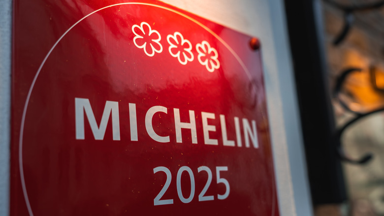 A red Michelin 2025 plaque with three stars