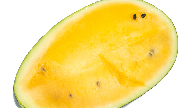 Halved Orangeglo watermelon on a white backdrop