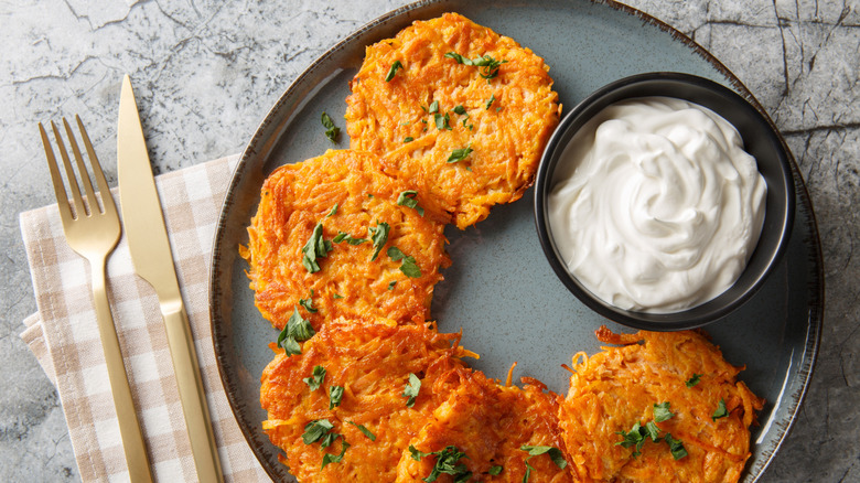 Homemade potato latkes with a side of sour cream