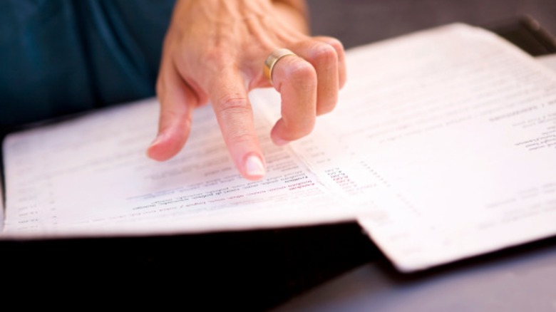 Customer hand pointing at menu