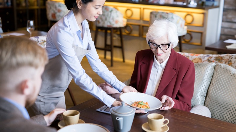 Boomer ordering from a waitress at a restaurant
