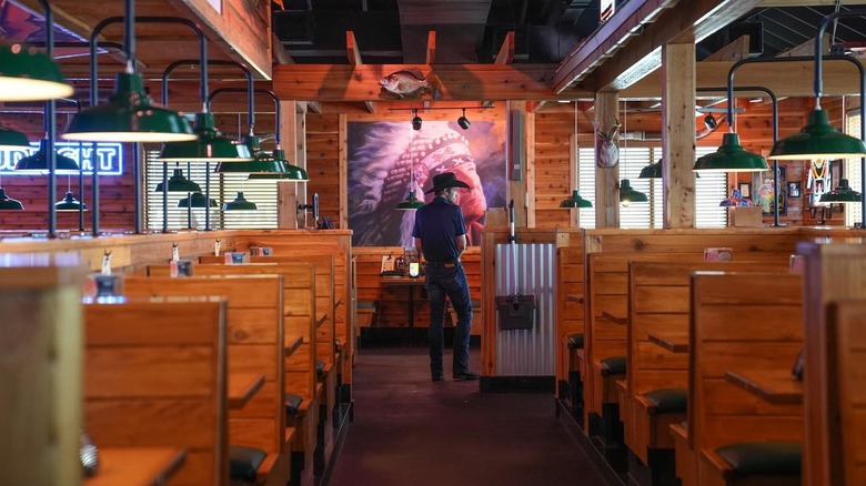 A man in a cowboy hat standing inside Texas Roadhouse