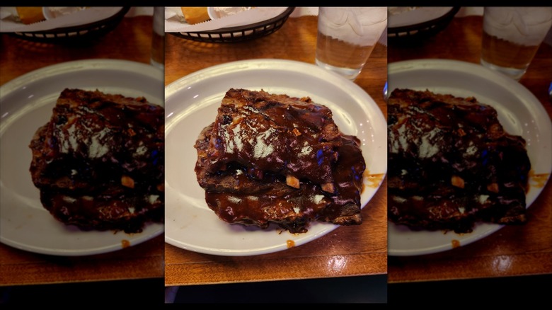 Baby back ribs on a table at a Texas Roadhouse, mirrored