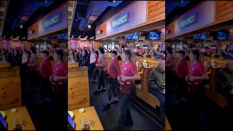 Texas Roadhouse staff doing a line dance in the restaurant, mirrored
