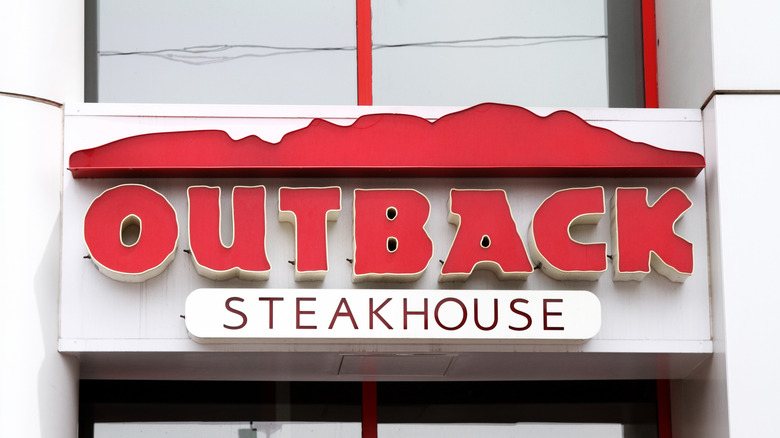 An Outback Steakhouse sign on the front of restaurant